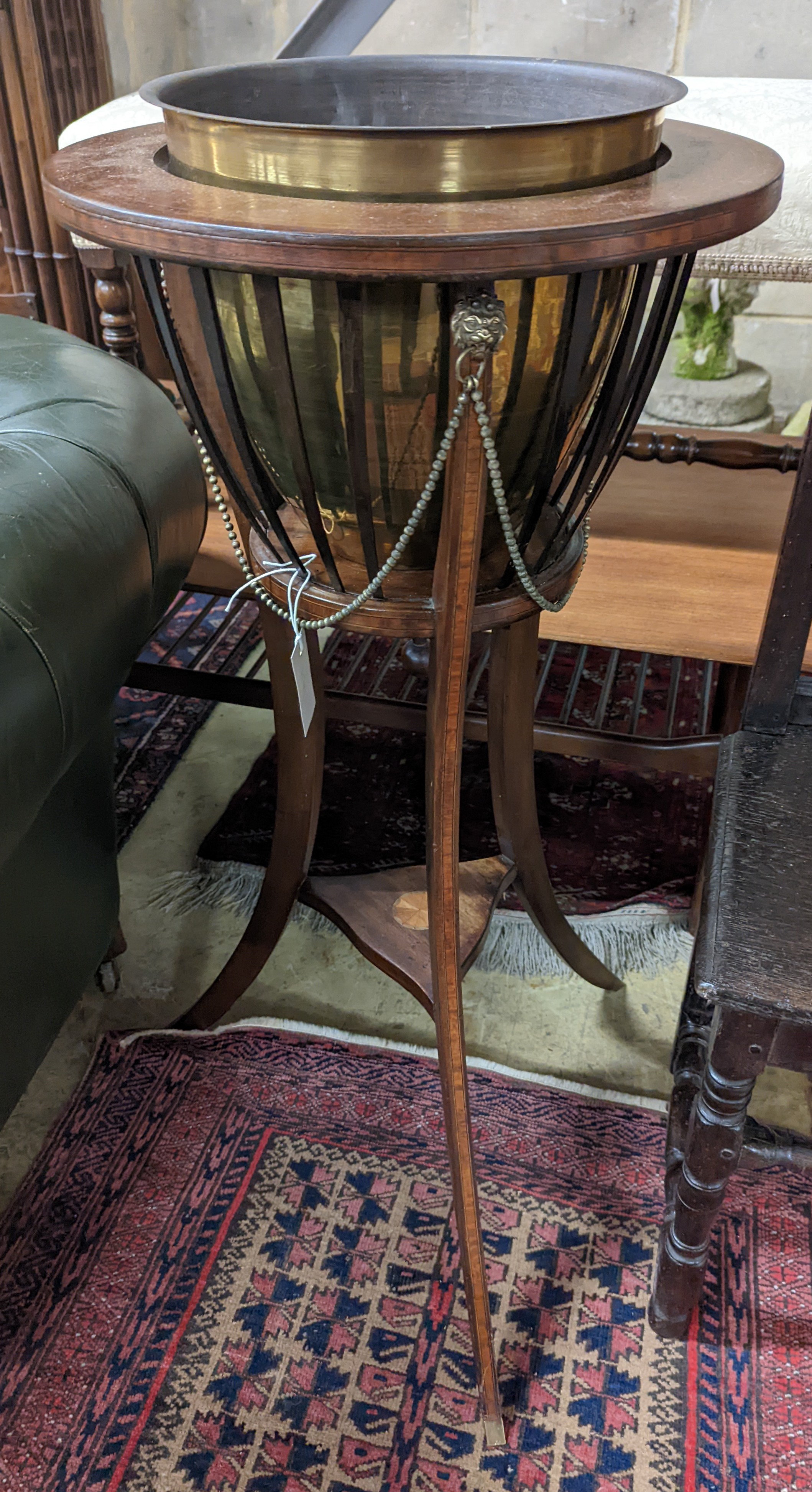 An Edwardian inlaid mahogany jardiniere with associated brass liner, height 92cm